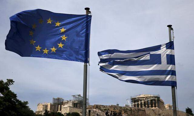An EU flag and a Greek national flag flutter as the ancient Parthenon temple is seen in the background in Athens
