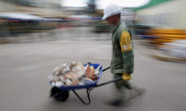 A member of a rescue team pushes a wheelbarrow at Enrique Rebsamen school after an earthquake hit Mexico City