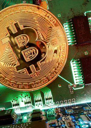 FILE PHOTO: Representation of the virtual currency Bitcoin is seen on a motherboard in this picture illustration