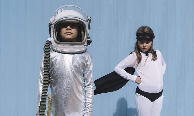 Two kids in astronaut and superhero costumes model released Symbolfoto PUBLICATIONxINxGERxSUIxAUTxHUNxONLY DAMF00045