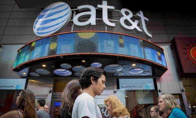 File photo of people walking past the AT&T store in New York's Times Square