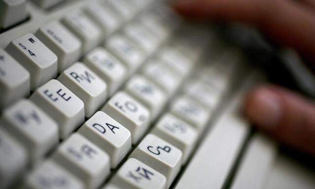 Employee types on computer keyboard with both Latin and Cyrillic letters in Sofia