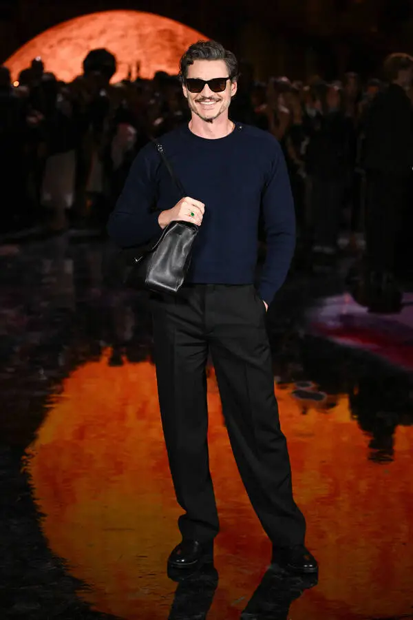 Actor and style role model Pedro Pascal with a Chanel handbag at the brand's fashion show.