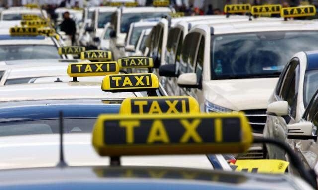 Cars a seen during a protest of licensed taxi drivers against a planned change of the passenger transport law in Berlin