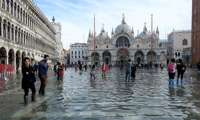 FILE PHOTO: Tourists walk in St. MarkâAeOes Square after days of severe flooding in Venice