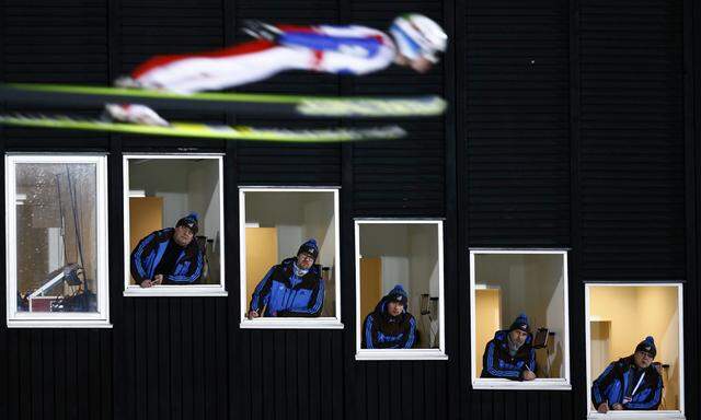 Velta of Norway soars past judges windows during the normal hill HS100 mixed team ski jumping event of the Nordic World Ski Championships in Falun