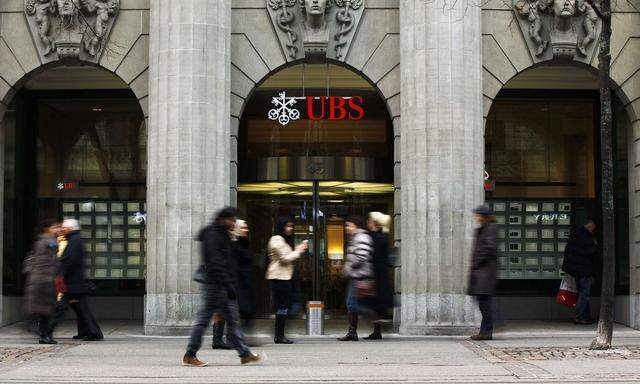 File photo of people walking in front of a branch of Swiss bank UBS in Zurich