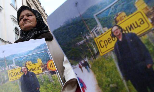 Representatives of the Association of Victims and Witnesses of Genocide hold a picture of the winner of the 2019 Nobel Prize for Literature Peter Handke in Srebrenica, during a protest in front of Sweden embassy in Sarajevo