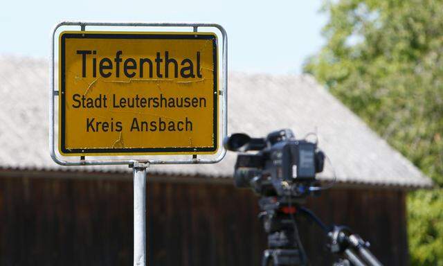 A traffic sign is pictured close to a video camera near a crime scene in Tiefenthal
