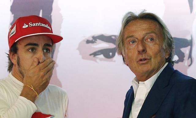 Ferrari Formula One driver Alonso of Spain looks on next to Ferrari President Montezemolo after the third practice session of the Italian F1 Grand Prix in Monza