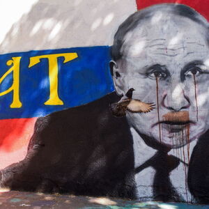 The pigeon flies over the mural of Russian President Vladimir Putin, in Belgrade