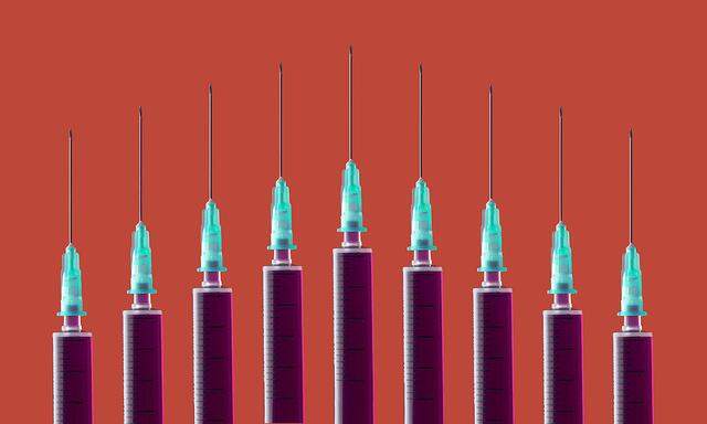 Multiple syringes organized in a pattern over orange background