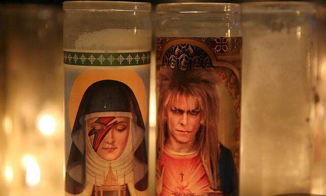 Candles are seen at a memorial for deceased musician David Bowie outside his former residence in the Manhattan borough of New York