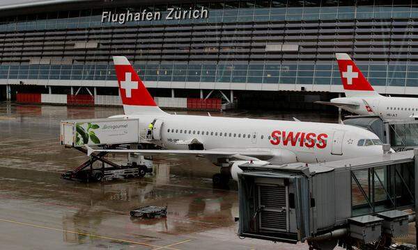 Vehicle of Gate Gourmet stands beside an Airbus A319-112 airplane of Swiss airline at Zurich airport