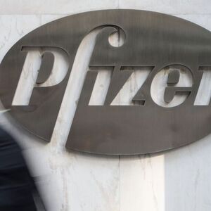 A man walks past Pfizer's world headquarters in New York