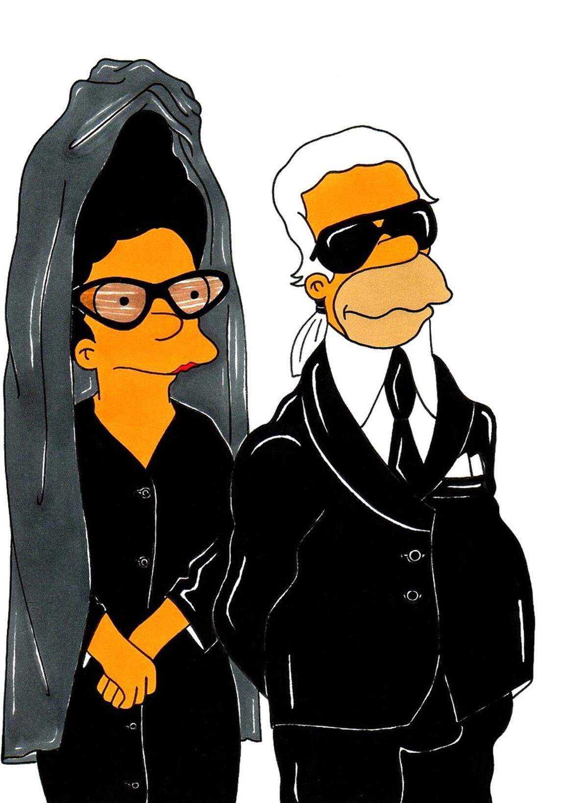 Huch, wer ist denn die Dame neben Karl "Simpsonfeld"? Grau-schwarzer Turban, Schleier und Brille? Dabei handelt es sich um eine der wohl exzentrischsten Figuren in der Modeszene.