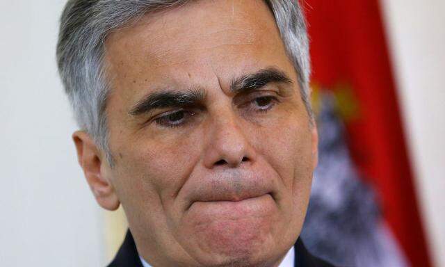 Austria's Chancellor Faymann listens during a news conference in Vienna