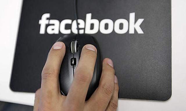 This Dec. 13, 2011 file photo, shows of worker inside Facebook headquarters in Menlo Park, Calif.  Fa