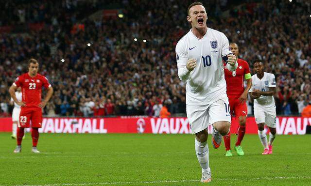 Wayne Rooney of England celebrates scoring his goal from the penalty spot to make it 2 0 during the