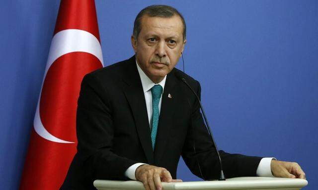 Turkish Prime Minister Erdogan listens to a question during a news conference in Ankara