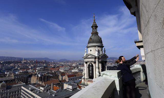 Tourists take a selfie from the balcony of the St Stephen Basilica in Budapest