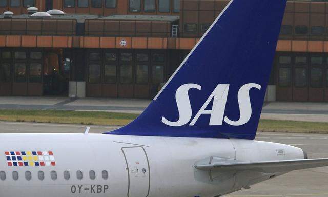 An aircraft operated by Scandinavian airline SAS is brought into position at the Berlin Tegel