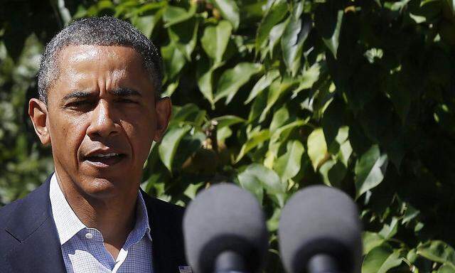 U.S. President Barack Obama walks out to make a statement about the violence in Egypt while at his rental vacation home on the Massachusetts island of Martha's Vineyard in Chilmark