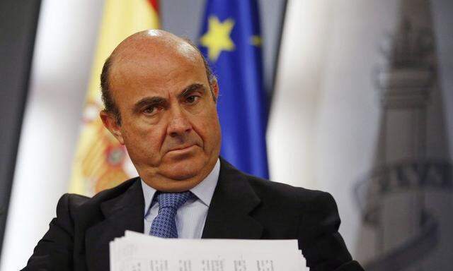 Spain's Economy Minister De Guindos looks on during a news conference in Madrid