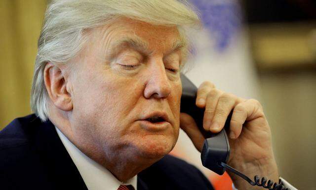U.S. President Donald Trump waits on the line as he call Prime Minister Leo Varadkar of Ireland to congratulate him for his victory, at the Oval Office of the White House in Washington