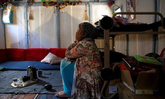 Syrian refugee Walaa sits inside her family´s tent at the Souda municipality-run camp on the island of Chios