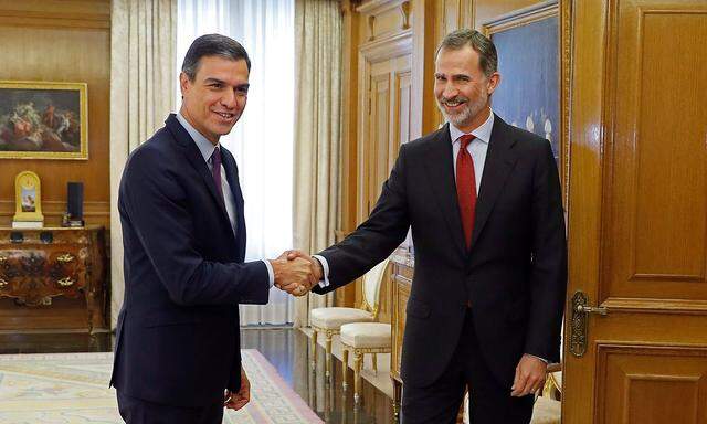 King Felipe VI of Spain R greets Spanish Prime Minister Pedro Sanchez L at Zarzuela Palace in