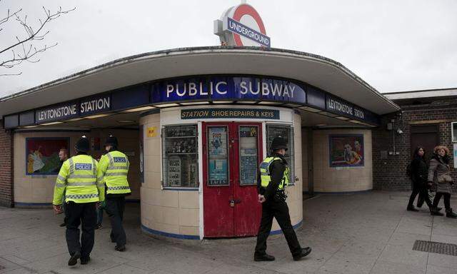 Police officers patrol outside Leytonstone Underground station in east London