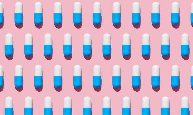 Repeated pills on pink background