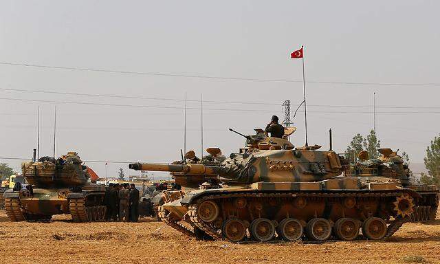 Turkish army tanks and military personnel are stationed in Karkamis on the Turkish-Syrian border in the southeastern Gaziantep province