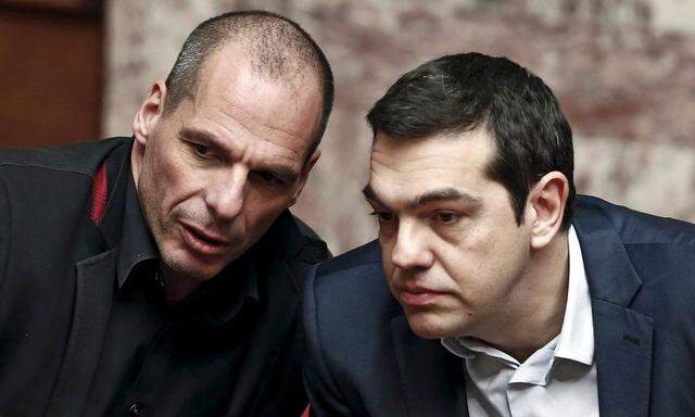 File photo of Greek PM Tsipras and Finance Minister Varoufakis talking during the first round of a presidential vote at the Greek parliament in Athens
