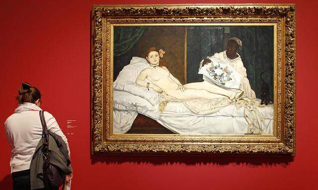 A visitor looks at the painting ´Olympia, 1863´ by French painter Edouard Manet (1832-1883) during the media day at the exhibition ´Manet, inventeur du Moderne´ at the Orsay museum in Paris