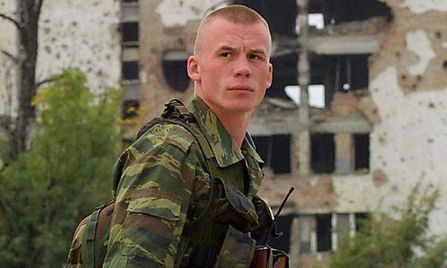 A Russian soldier looks on while patrolling Grozny, in this Oct. 4, 2003 file photo. Presi