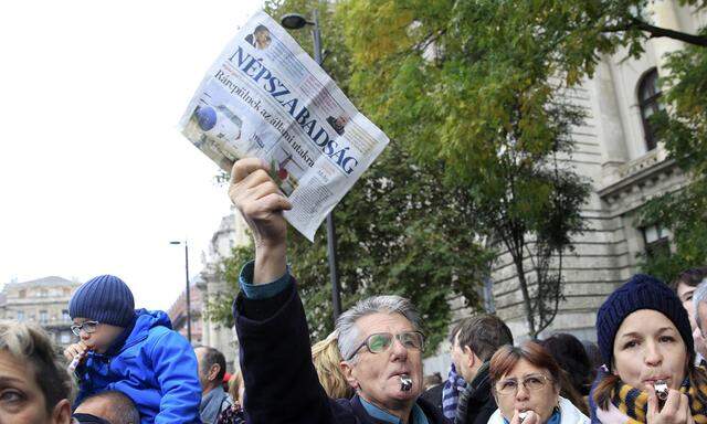 Protester holds a copy of the leftist newspaper Nepszabadsag during an anti-government demonstration in Budapest