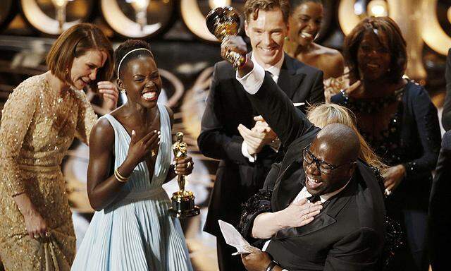 Director and producer McQueen celebrates after accepting the Oscar for best picture for his film ´12 Years a Slave´ at the 86th Academy Awards in Hollywood