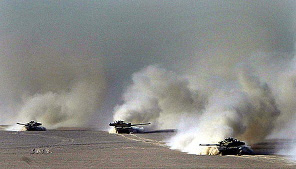 Bush stellt in einer Fernsehansprache dem irakischen Diktator ein Ultimatum: Sollten Saddam und seine Söhne das Land nicht innerhalb von 48 Stunden verlassen, würden die USA zu einem "Zeitpunkt ihrer Wahl" angreifen.Am Bild: "Operation Telic": Britische Panzerfahrzeuge fahren am 17. März 2003 durch die Wüste von Kuwait.