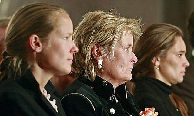 Widow Claudia Haider, center, with her daughters Cornelia, left, and Ulrike, right, attend the church