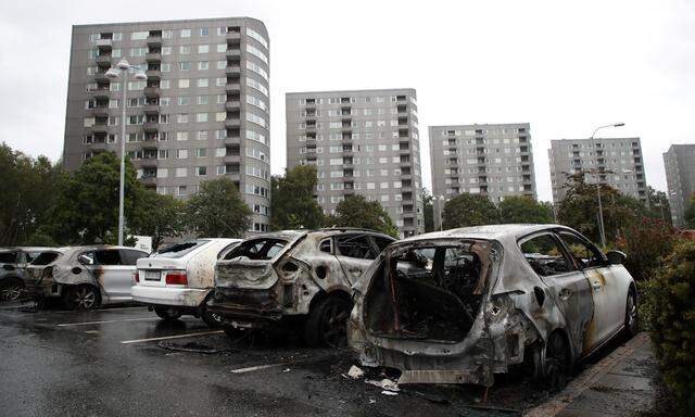Burned cars are pictured at Frolunda Square in Gothenburg