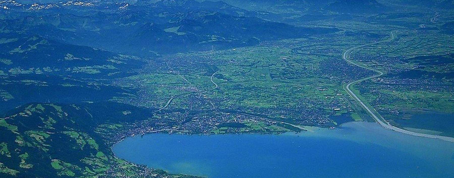 Blick von Norden über den Bodensee aufs Rheintal. Rechts vom Rhein ist die Schweiz, das Ufer am unteren Bildrand gehört zu Deutschland. Bregenz ist links im Bild am Ostende des Sees.