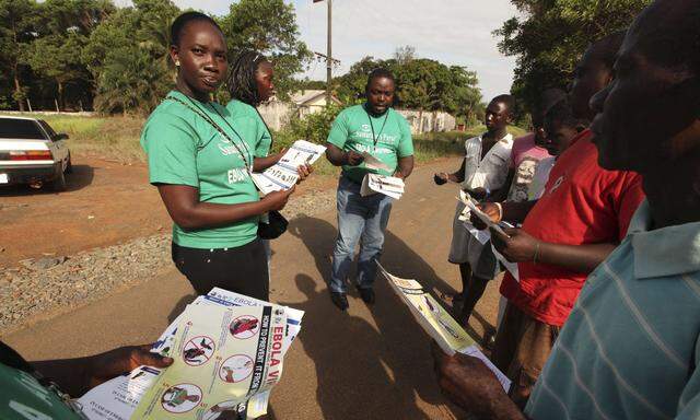 A Samaritan´s Purse team member hands out pamphlets to educate the public on the Ebola virus in Monrovia in this undated handout photo