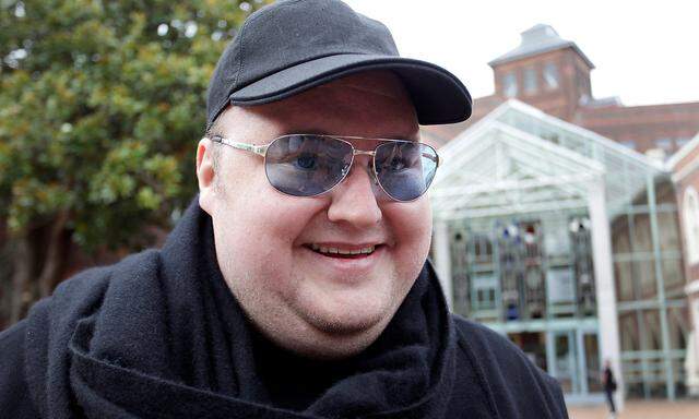 FILE PHOTO: Megaupload founder Kim Dotcom talks to members of the media as he leaves the High Court in Auckland