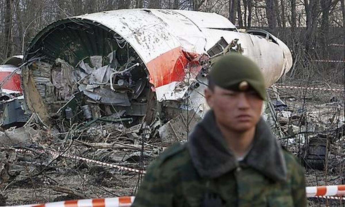 File photo of Russian serviceman standing guard near part of the wreckage of a Polish government Tupo