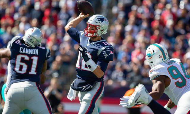 New England Patriots quarterback Tom Brady 12 throws a pass in the first quarter against the Miam