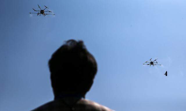 Drone flies and sprays chemicals during an operation to reduce air pollution in Bangkok