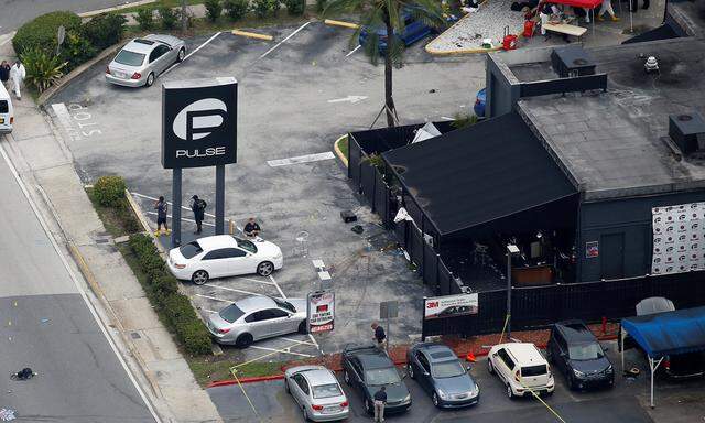 Investigators work the scene following a mass shooting at the Pulse gay nightclub in Orlando Florida