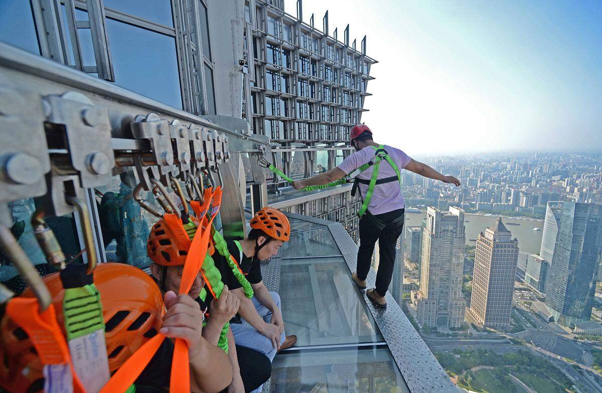 Noch ein bisschen luftiger wird es am Jin Mao Tower in Shanghai, hier fehlt das Geländer zum Festkrallen. Nur ein Klettergeschirr hält die Besucher des Skywalks in 341 Meter Höhe in Sicherheit.